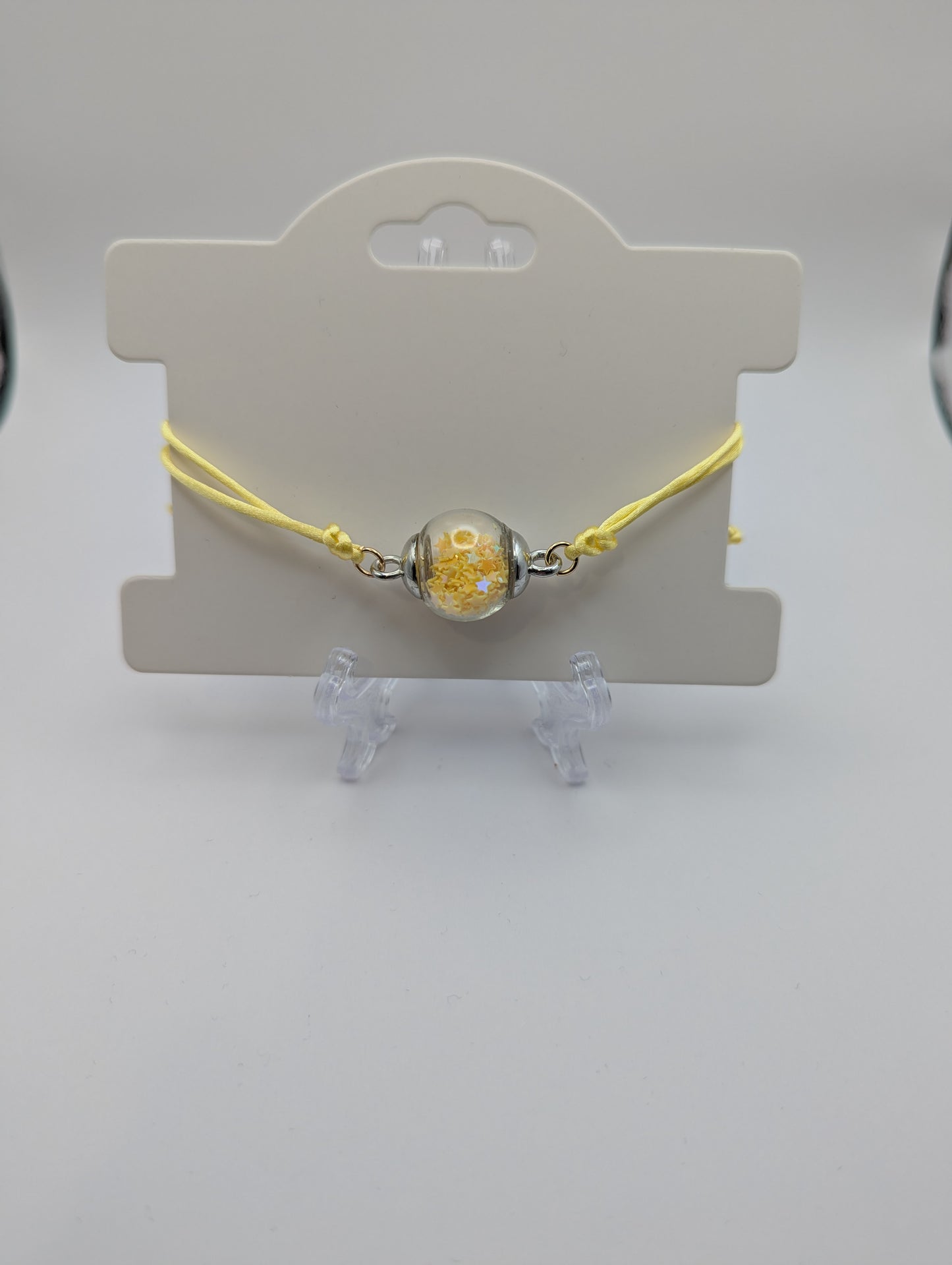Yellow Star Glitter Globe Bracelet on Adjustable Nylon Cord