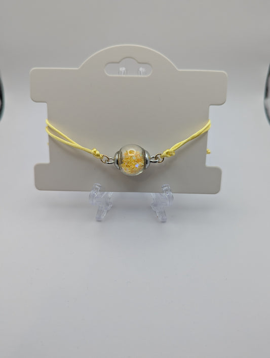 Yellow Star Glitter Globe Bracelet on Adjustable Nylon Cord
