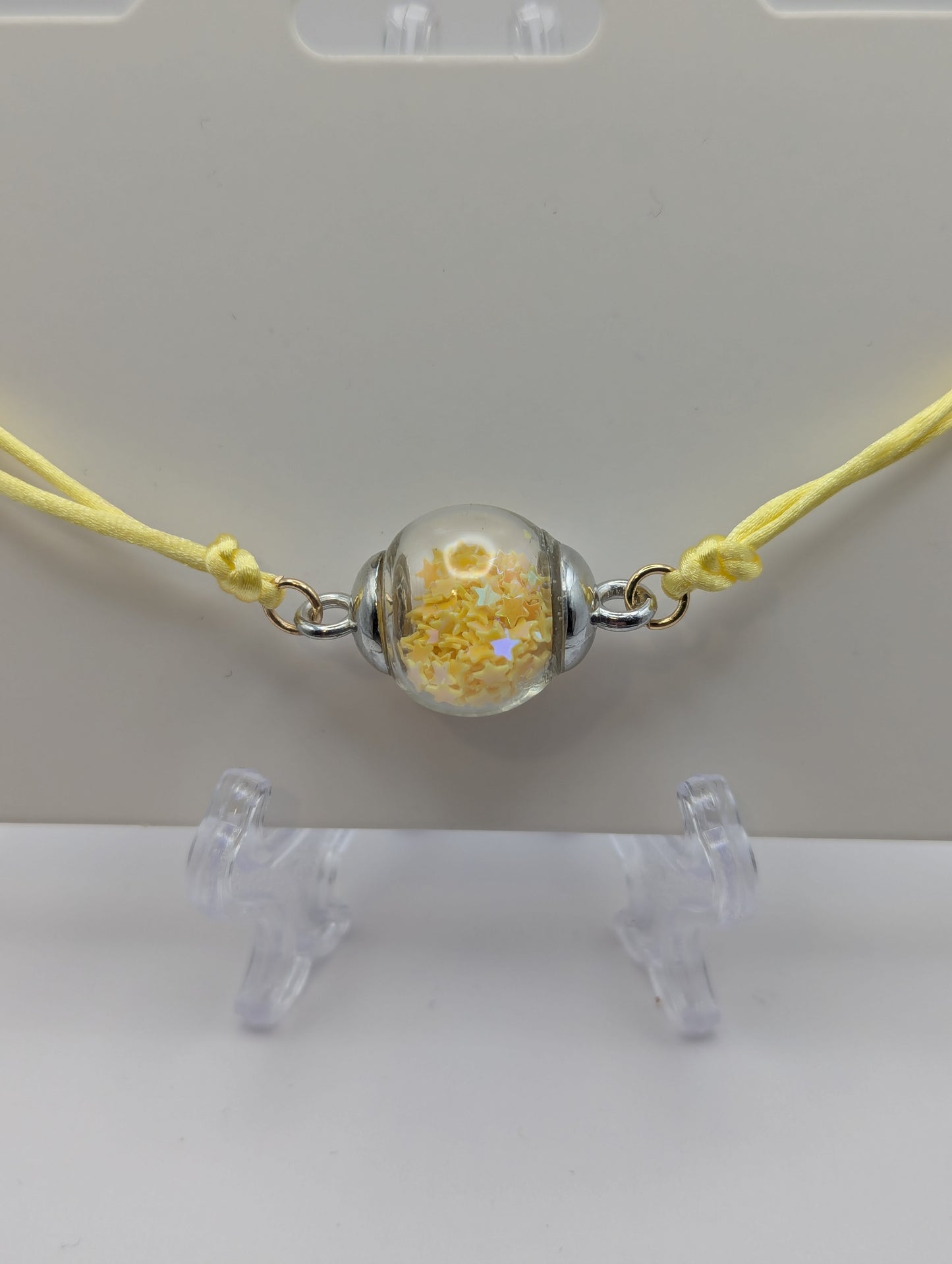 Yellow Star Glitter Globe Bracelet on Adjustable Nylon Cord