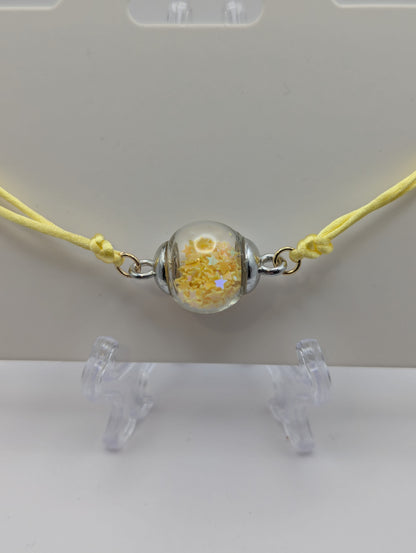 Yellow Star Glitter Globe Bracelet on Adjustable Nylon Cord