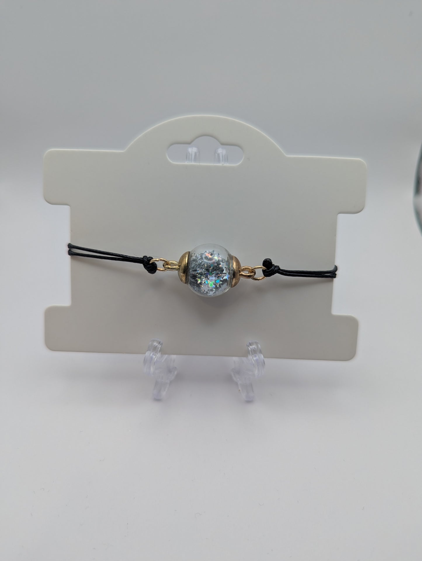 Silver Star Glitter Globe Bracelet on Adjustable Black Nylon Cord