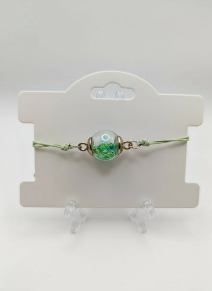 Green Petal & Crystal Glitter Globe Bracelet on Green Cord