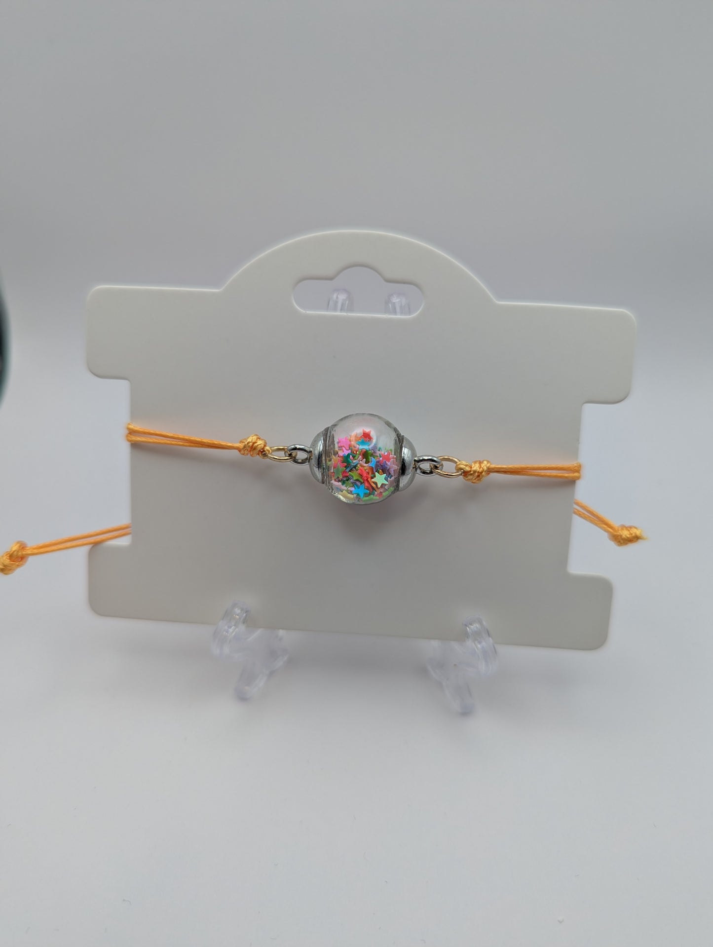 Multicolor Star Glitter Globe Bracelet on Adjustable Yellow Nylon Cord