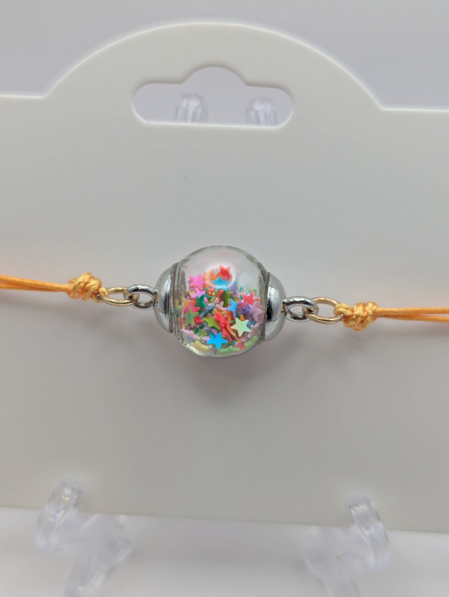 Multicolor Star Glitter Globe Bracelet on Adjustable Yellow Nylon Cord