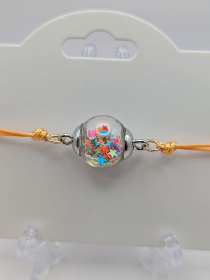 Multicolor Star Glitter Globe Bracelet on Adjustable Yellow Nylon Cord
