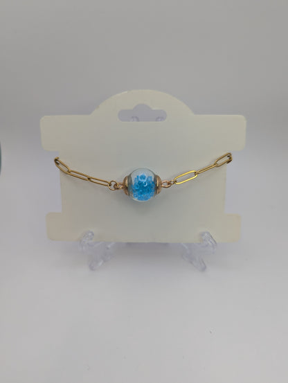 Aquamarine Rhinestone Globe on Gold Paperclip Bracelet With Dolphin Accent