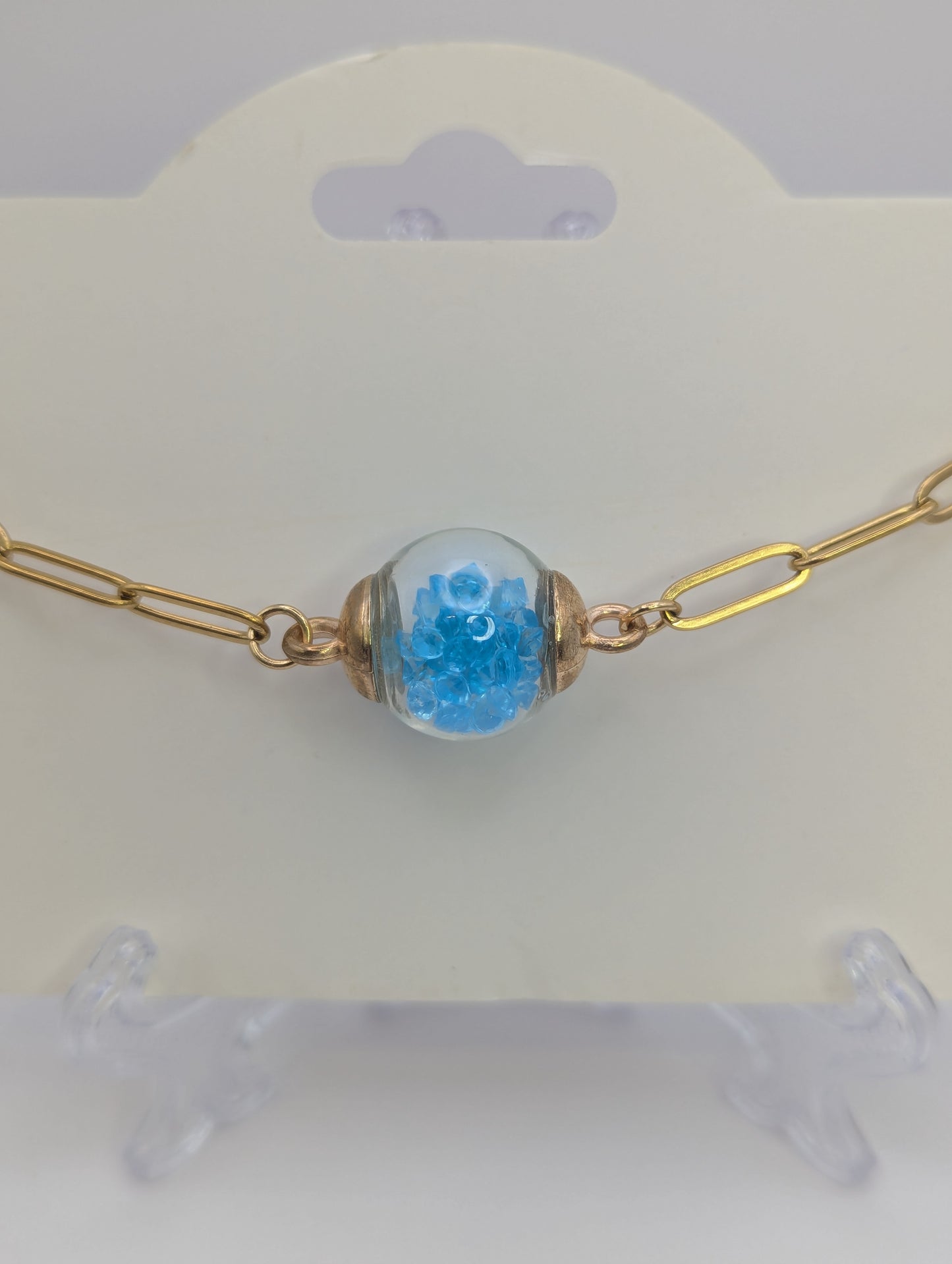 Aquamarine Rhinestone Globe on Gold Paperclip Bracelet With Dolphin Accent