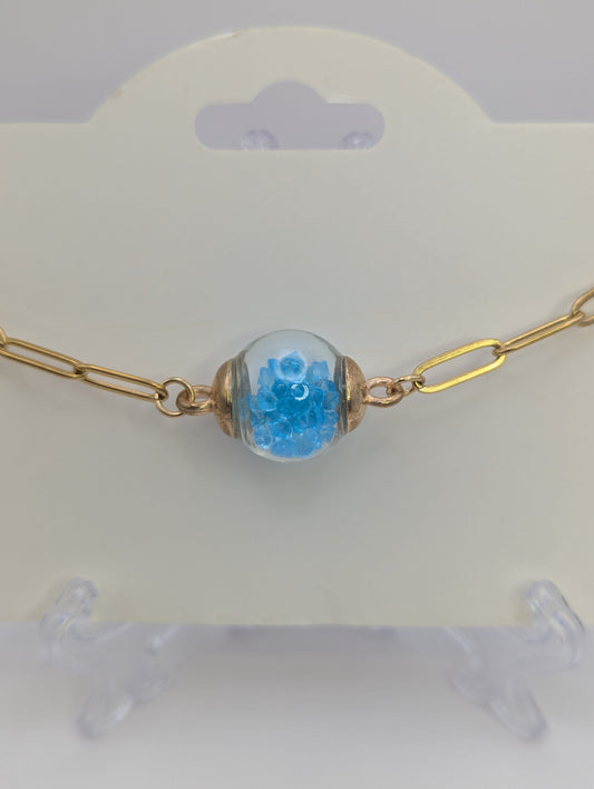 Aquamarine Rhinestone Globe on Gold Paperclip Bracelet With Dolphin Accent