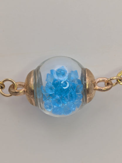 Aquamarine Rhinestone Globe on Gold Paperclip Bracelet With Dolphin Accent