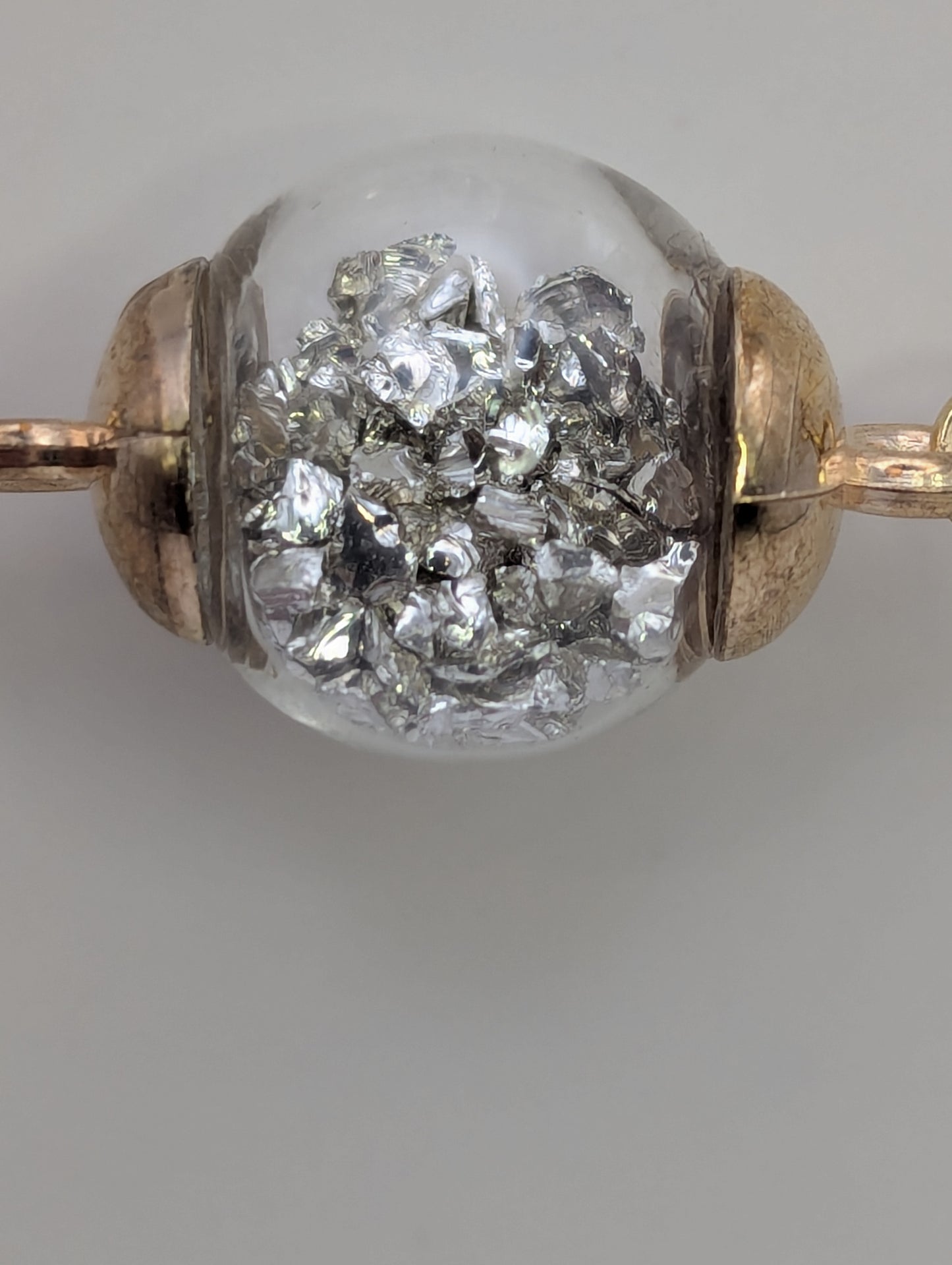Silver Stone Flecks In Globe on Gold Paperclip Chain Bracelet