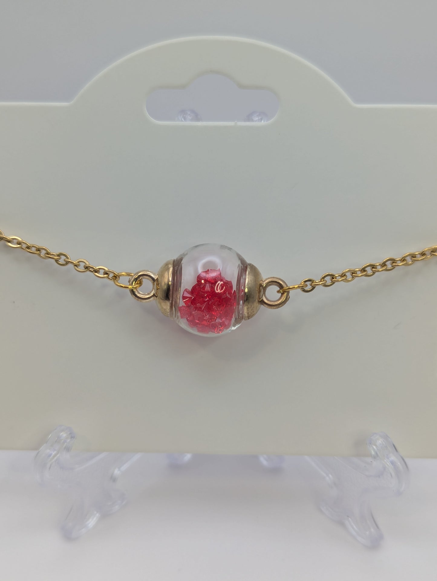 Red Rhinestones in Glass Globe on Gold Bracelet
