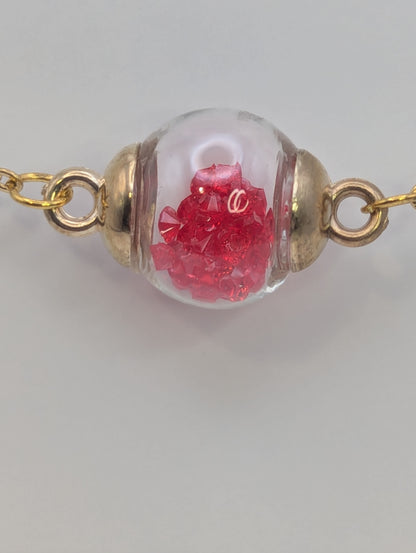 Red Rhinestones in Glass Globe on Gold Bracelet