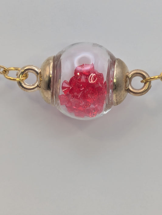 Red Rhinestones in Glass Globe on Gold Bracelet